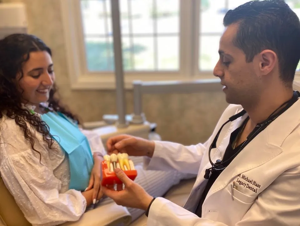 Dr. Nasr from Legacy Dental in Metuchen explaining dental implants to patient