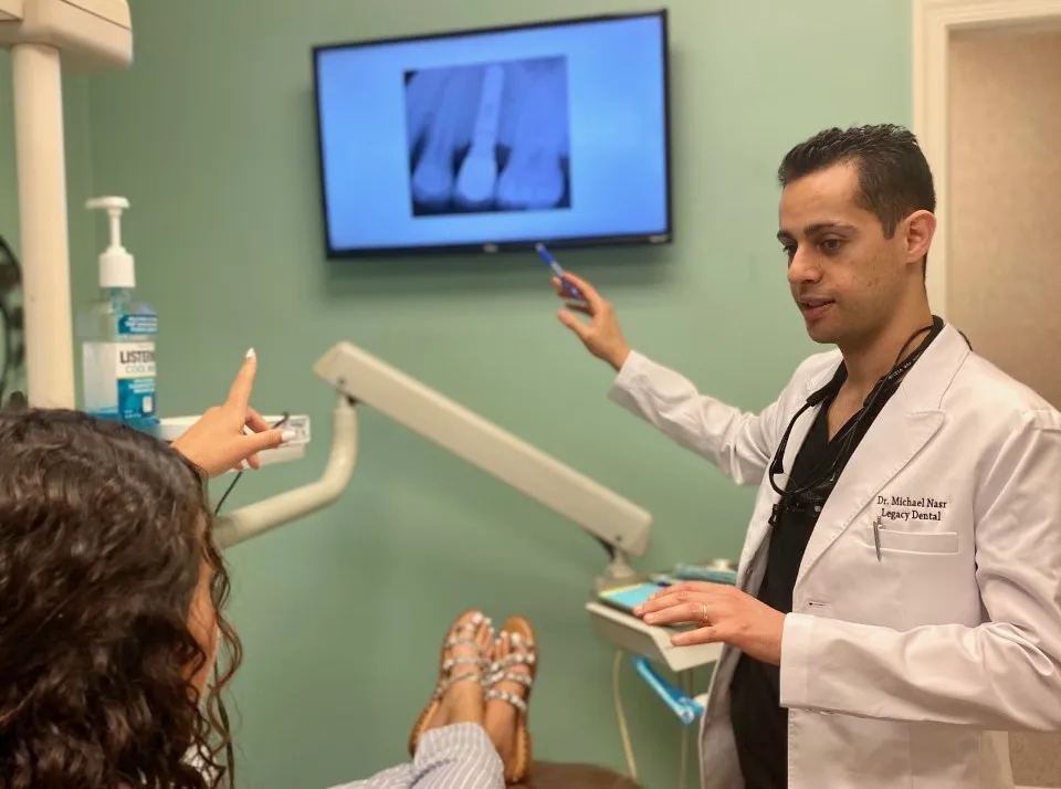 Dr. Nasr from Legacy Dental in Metuchen showing patient dental implant x-ray