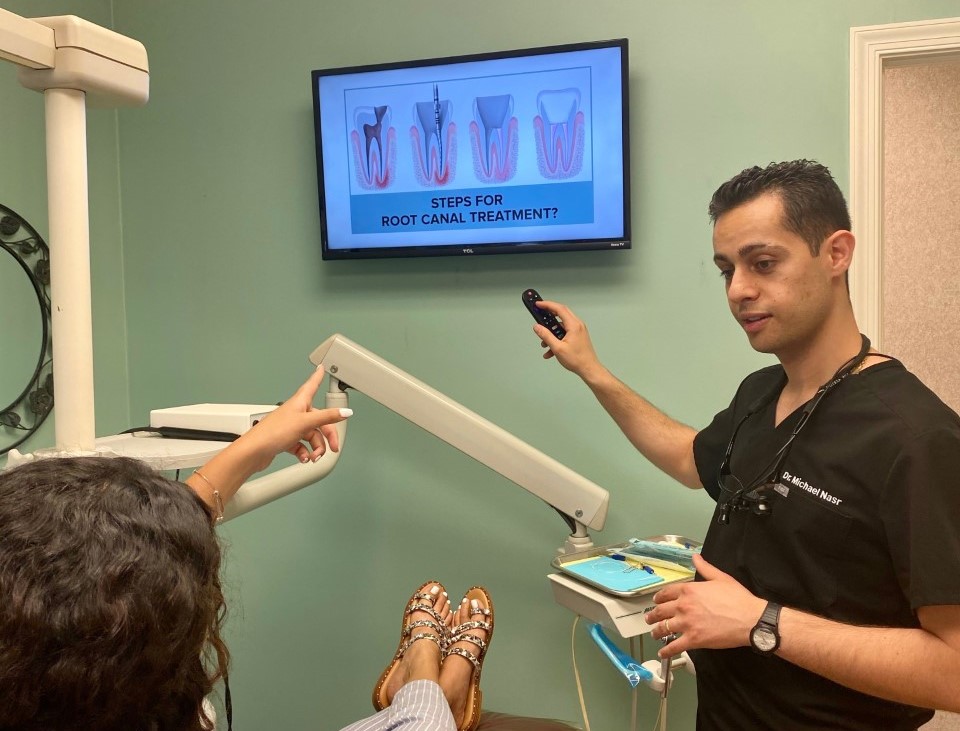 Dr. Nasr from Legacy Dental in Metuchen explaining root canals to patient