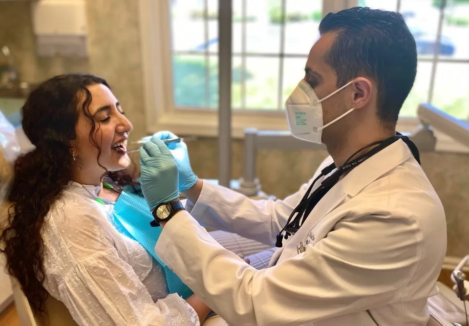 Dr. Nasr from Legacy Dental in Metuchen cleaning and analyzing patient's teeth